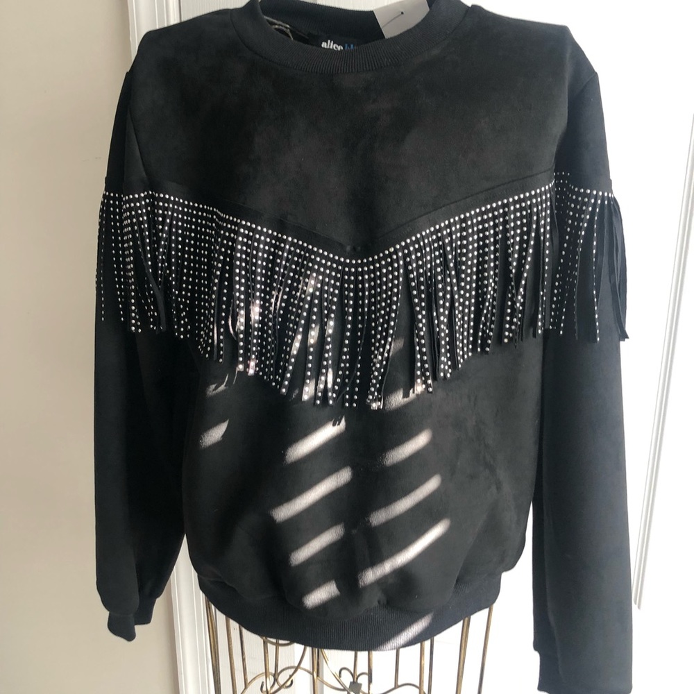 Black long sleeve shirt with fringes on the sleeve and front of shirt